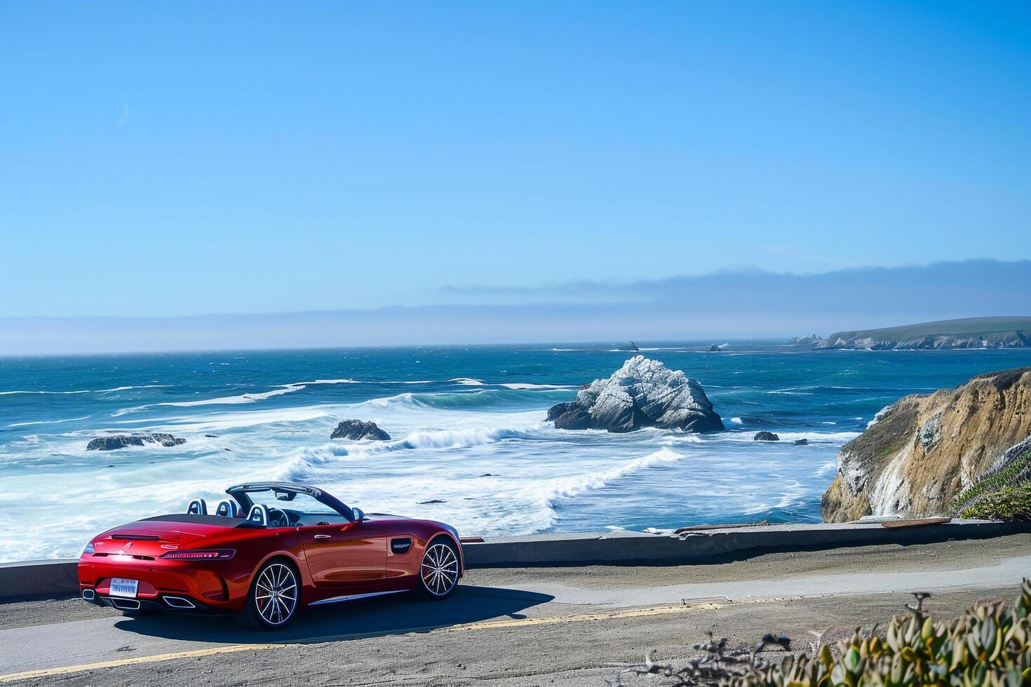 Luxury New convertible parked on scenic coastal road with ocean waves crashing on rocks and clear blue sky as background photo