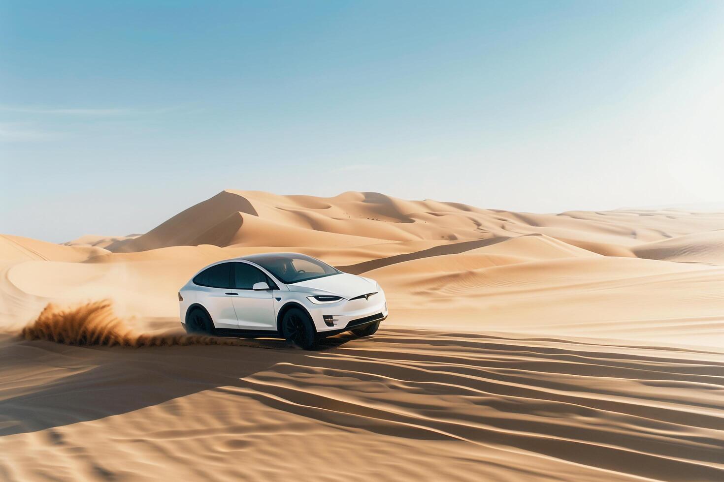 Electric SUV driving on an off road path through desert landscape with sand dunes and clear blue skies photo