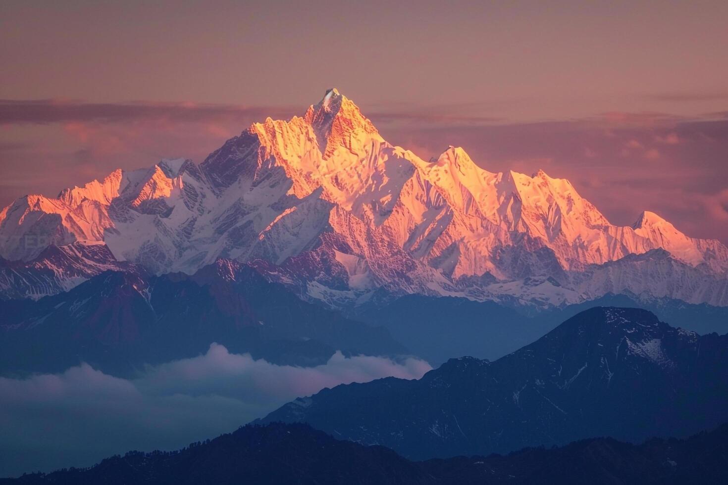 Snowy peaks of mountain range glowing in the golden light of sunrise background photo