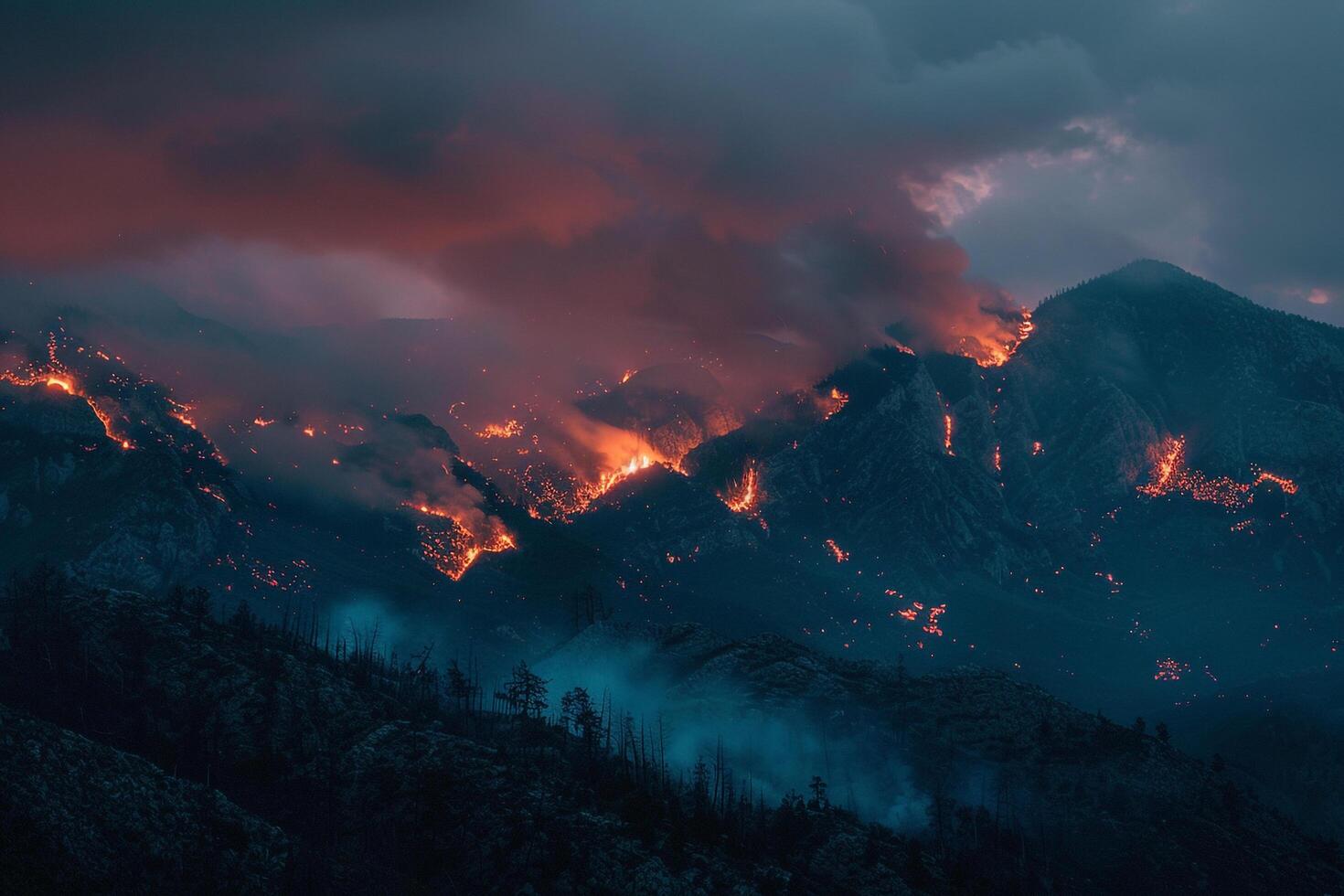 Wildfire Mountain Background Wildfire spreading across rugged mountains casting an orange glow against the twilight sky. photo