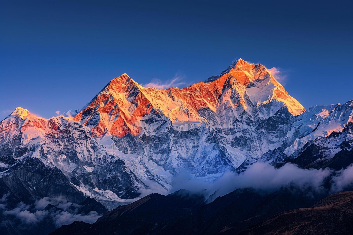 Snowy peaks of mountain range glowing in the golden light of sunrise background photo