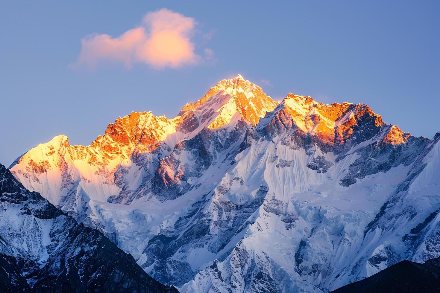 Snowy peaks of mountain range glowing in the golden light of sunrise background photo