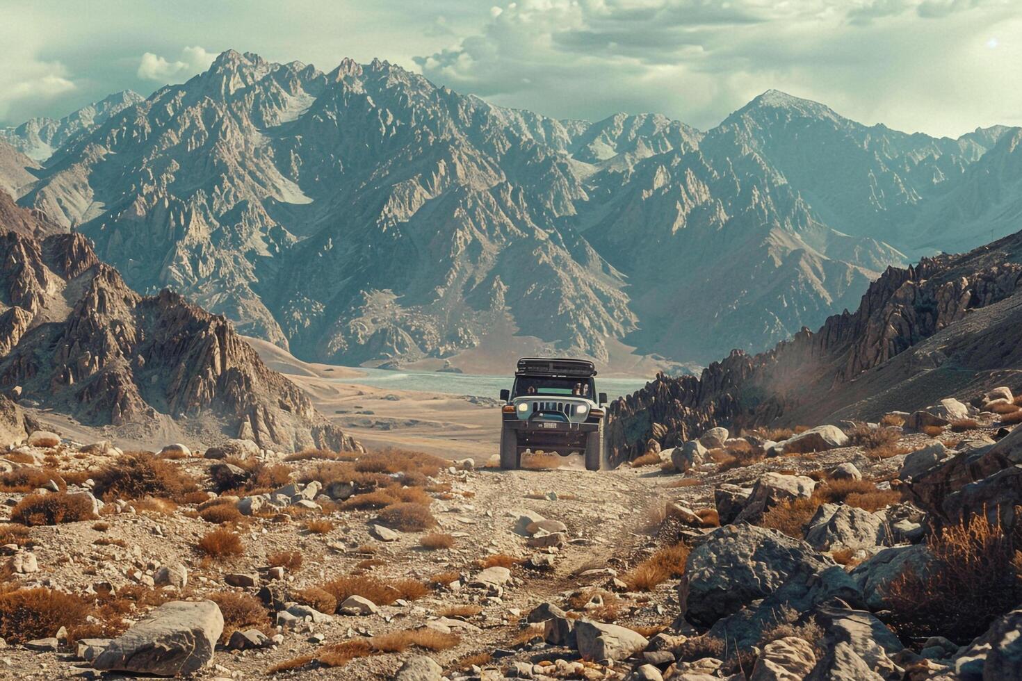 Adventure Off Road Vehicle Navigating Rugged Terrain with Rocky Mountains in the Background   nature background photo
