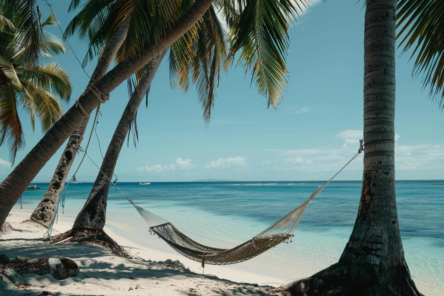 Beach with palm trees and hammock tied between two trees overlooking turquoise waters nature background photo