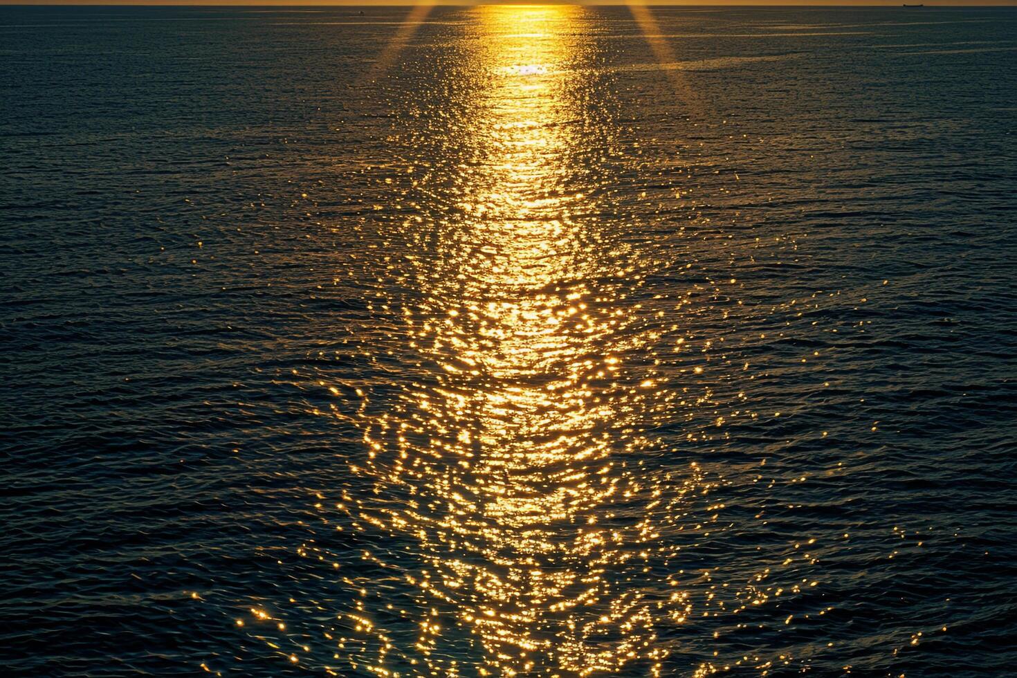Seascape Sunlight creating shimmering path on the surface of the sea during sunset  nature background photo