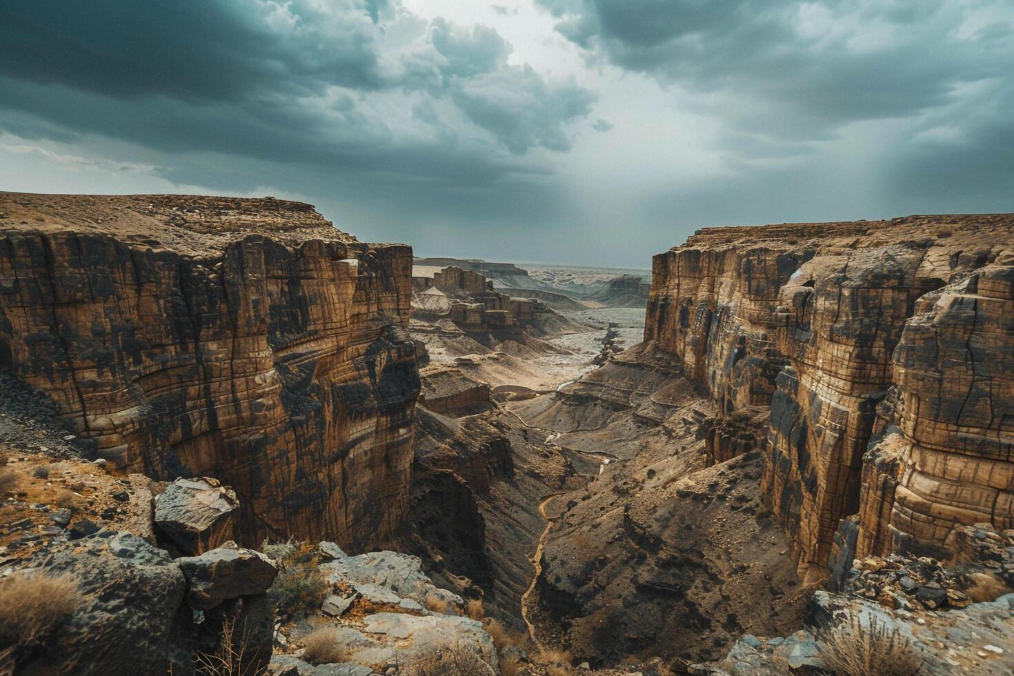 Towering Rock Formations in Vast Desert with Winding Canyon Under Dramatic Sky Background Nature photo