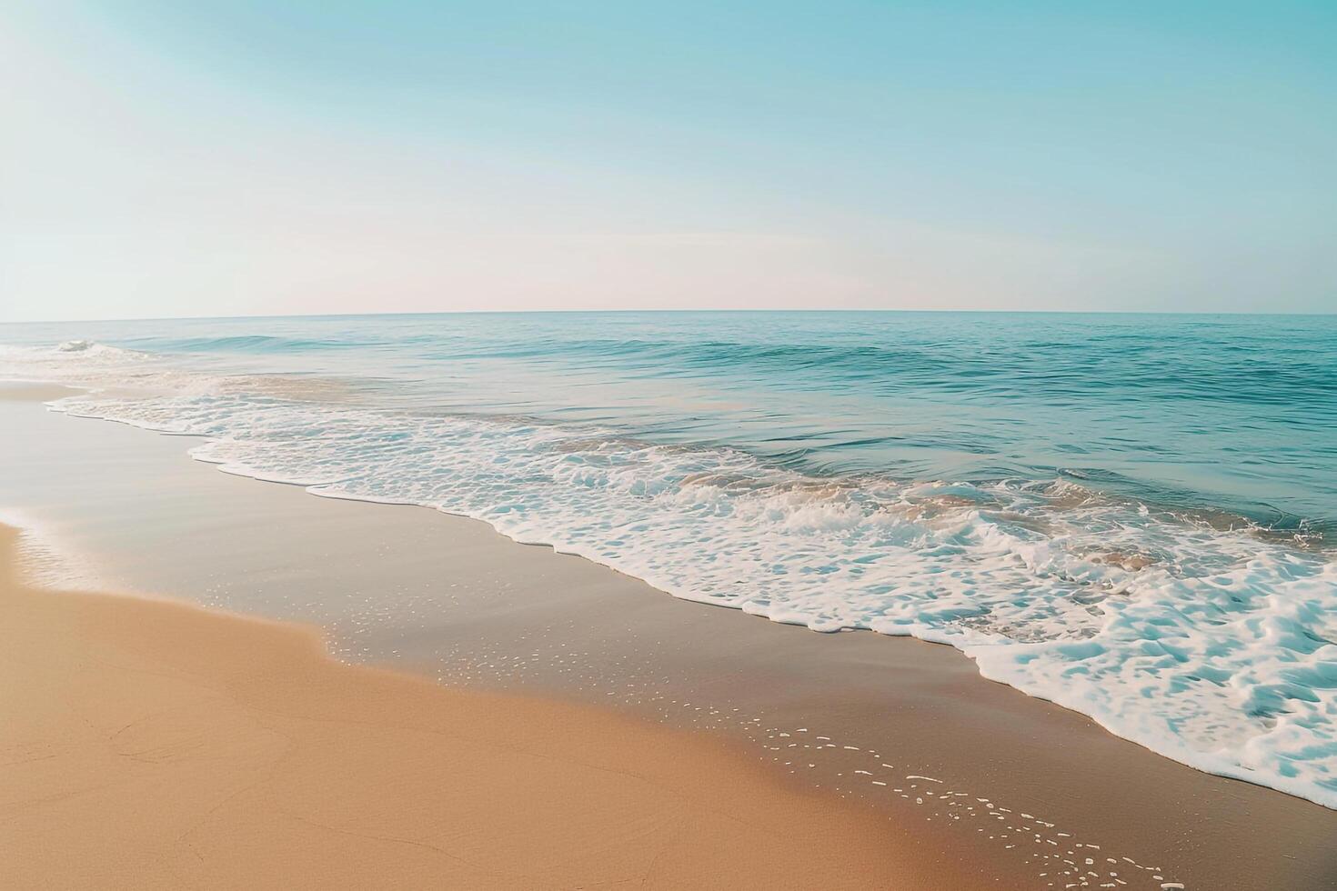 Empty Golden Sand Beach with Gentle Waves and Clear Blue Sky   nature background photo