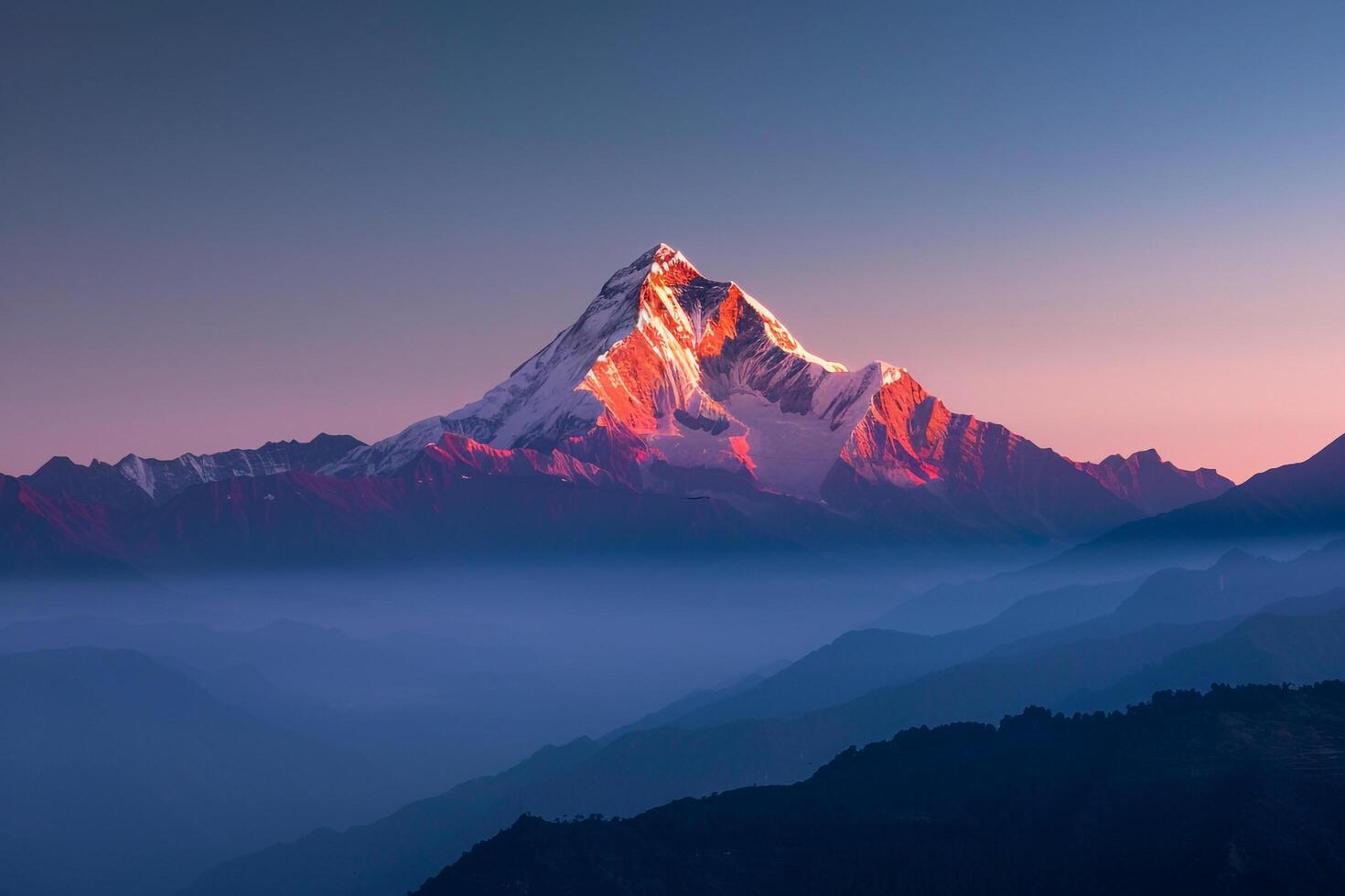 Snow Capped Mountain Peak Glowing in the First Light of Dawn Background photo