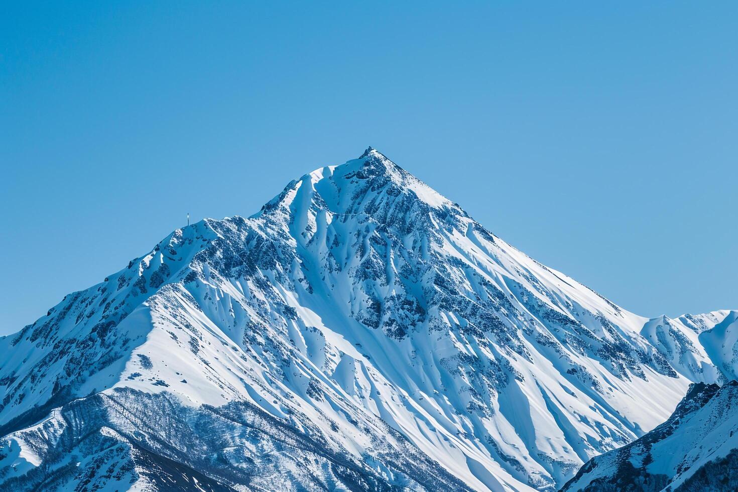 Snowy Mountain Peak Against a Clear Blue Sky. Nature. Background photo
