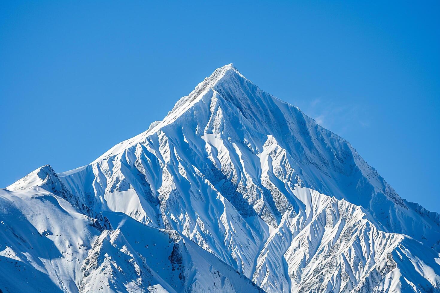 Snowy Mountain Peak Against a Clear Blue Sky. Nature. Background photo