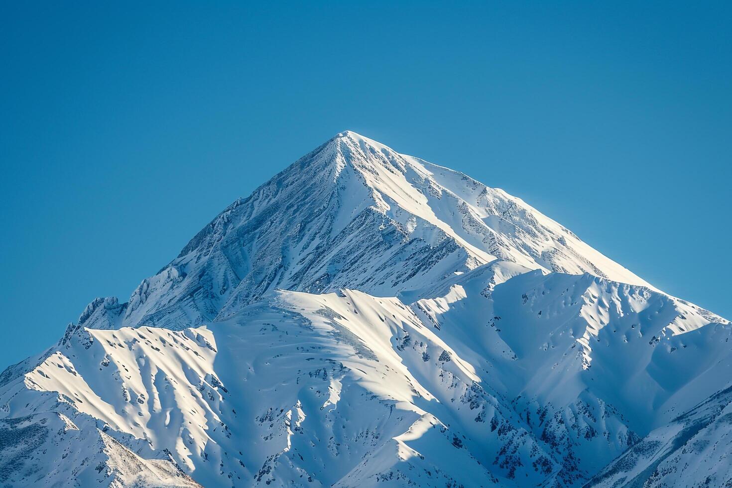 Snowy Mountain Peak Against a Clear Blue Sky. Nature. Background photo