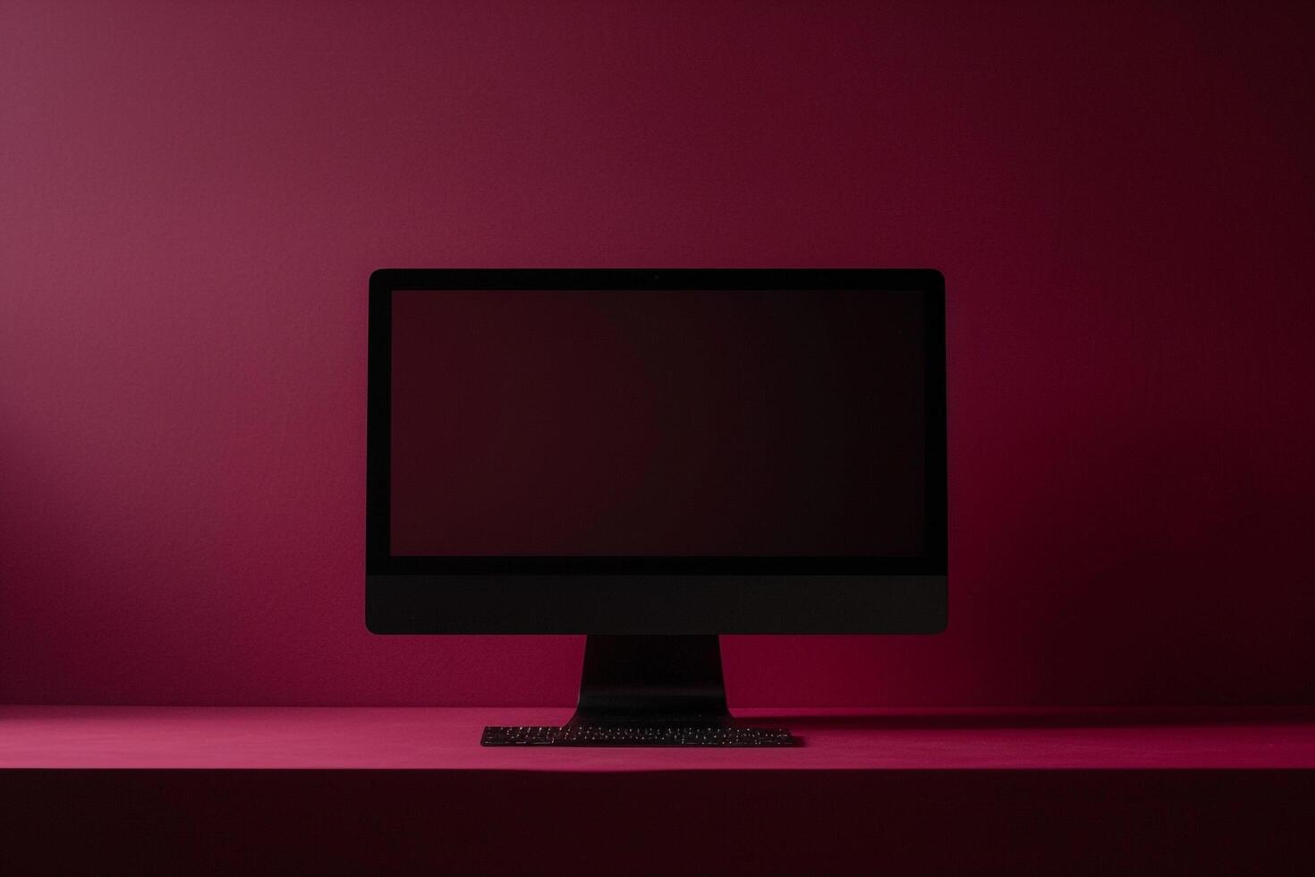 Computer monitor mockup on rich burgundy background with blank screen photo