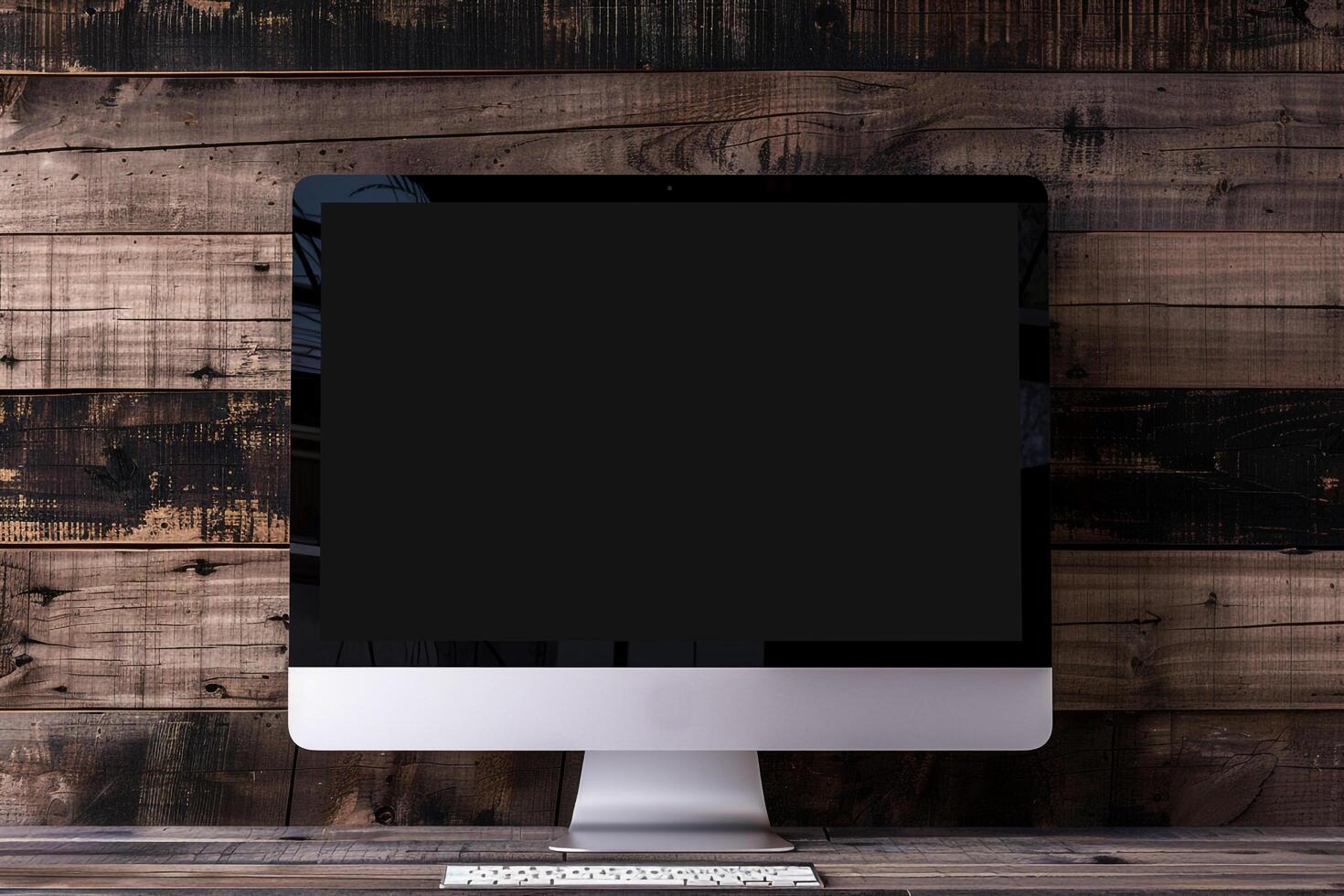 Computer monitor mockup with blank screen on deep walnut wood background photo