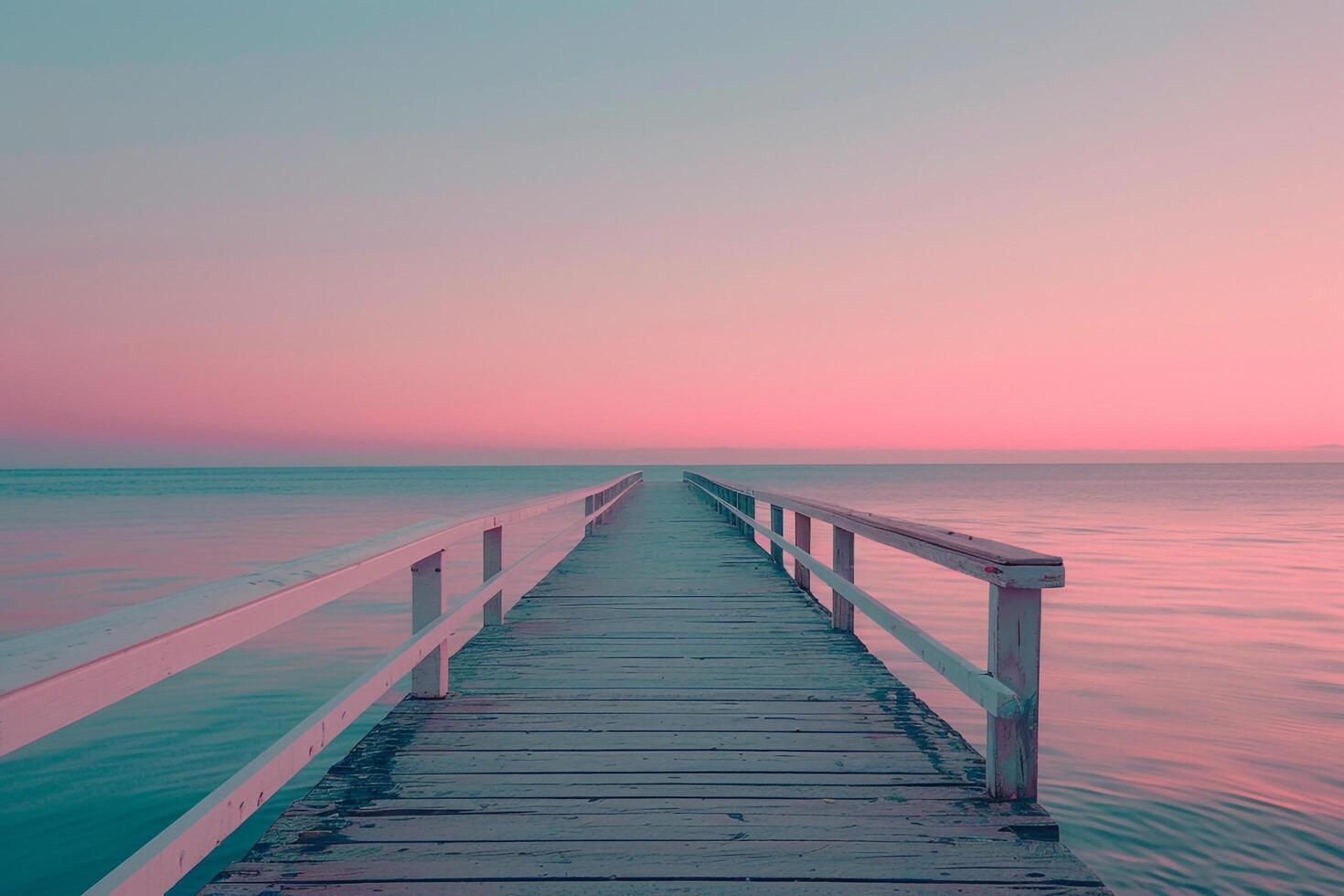 Pier Stretching into Calm Ocean Under  Pink Sunset Sky Background photo