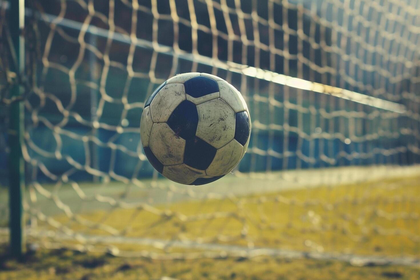Soccer Ball Mid Air Near Goal with Vacant Stands photo
