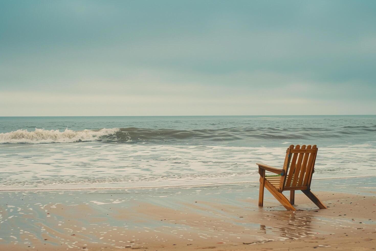 Single beach chair facing the tranquil ocean with gentle waves offering a peaceful and scenic coastalbackground photo
