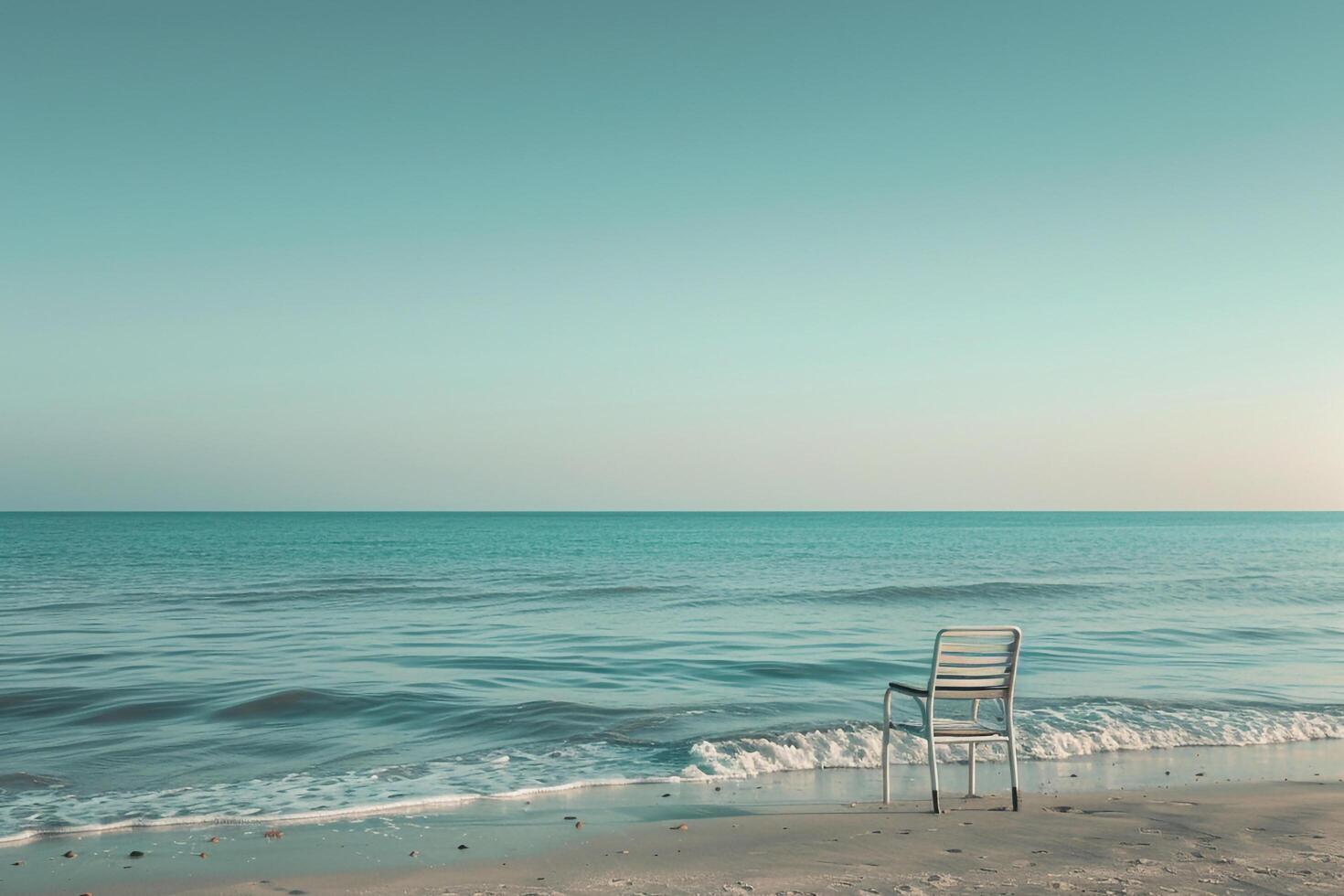 Beach chair alone facing the gentle ocean waves providing a serene and calming seaside perspective background photo