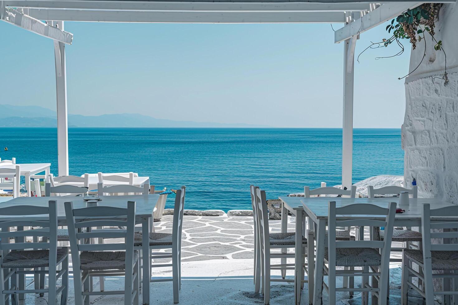 White washed taverna on the beach with a stunning  of the azure sea creating a peaceful seaside atmosphere background photo