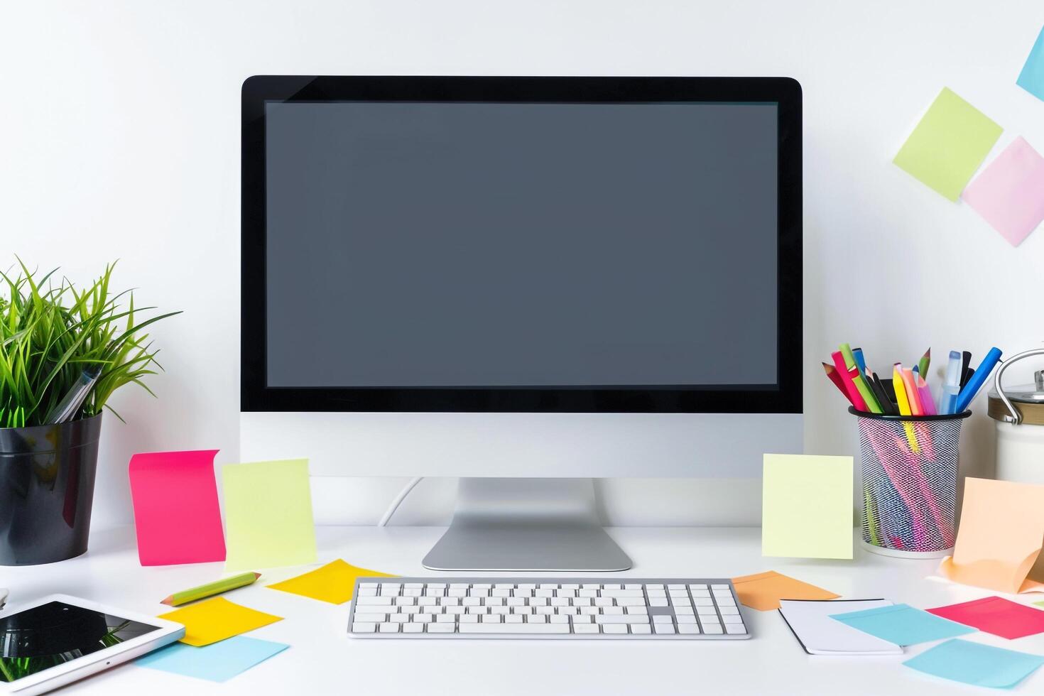 Computer mockup on a  white desk with sticky notes around ideal for office setup and  work background photo