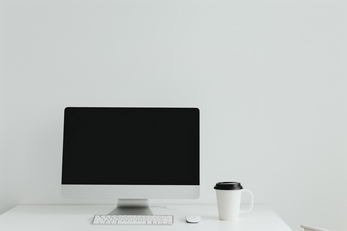 White desk with computer mockup sticky notes and coffee cup creating a  and  workspace setup background photo