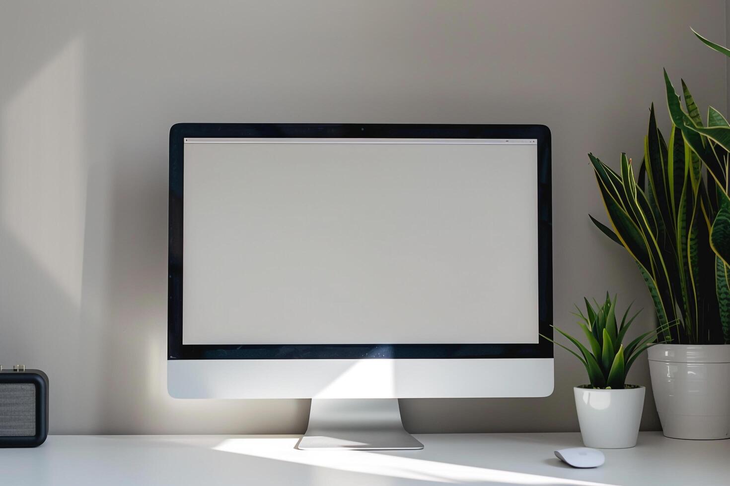 Computer mockup on a white desk with plant for a  office background photo