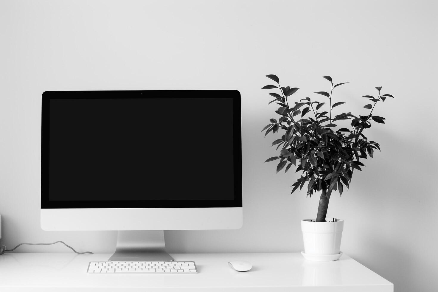 Computer mockup on a white desk with plant and istic design photo