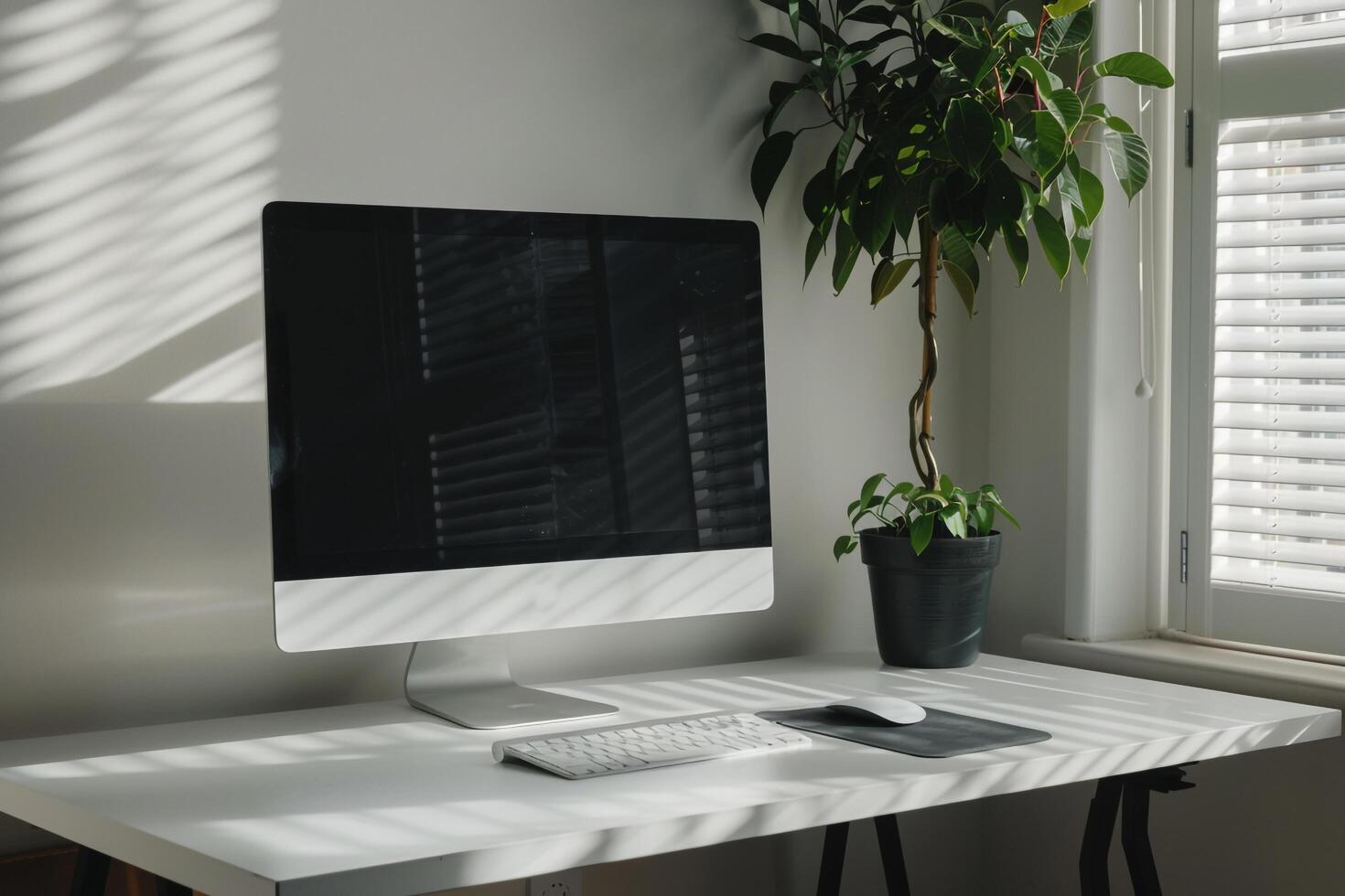Computer mockup with plant on a white desk for a contemporary workspace photo