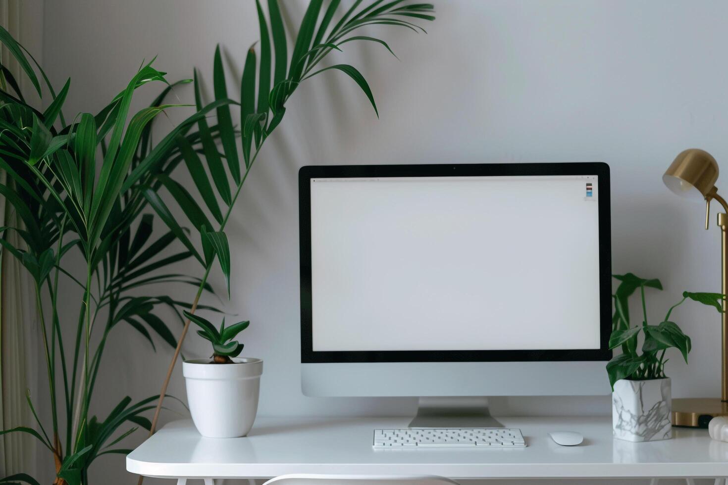 Computer mockup with plant on a white desk for a ist workspace photo