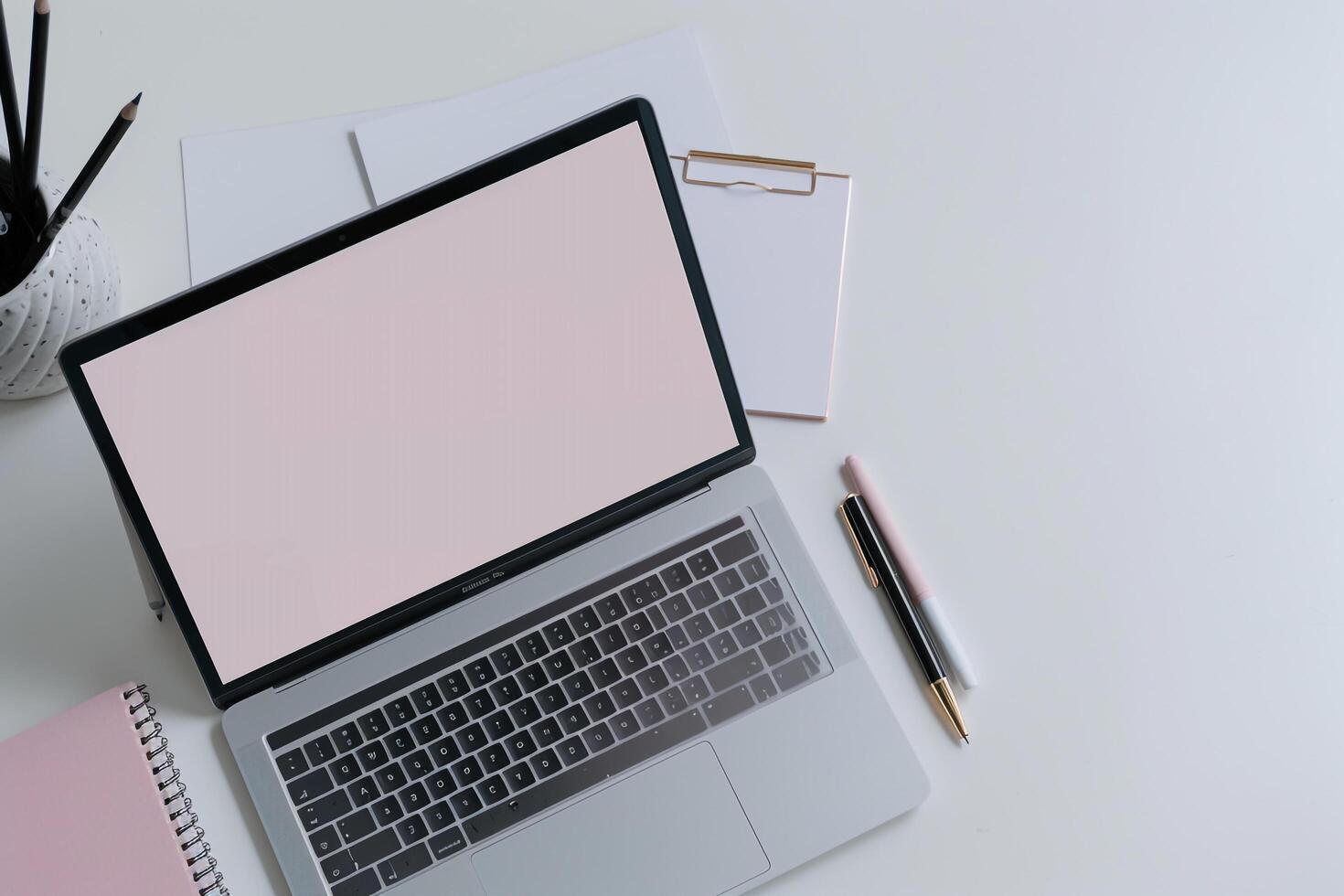 White desk Laptop Mockup Background with pens and notepad for productivity photo