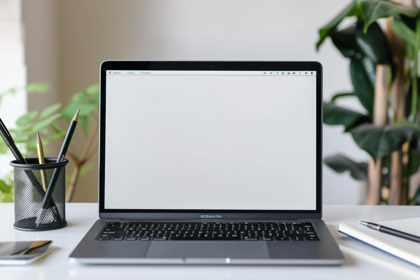 Laptop Mockup Background on white desk with notepad and pens for productivity photo