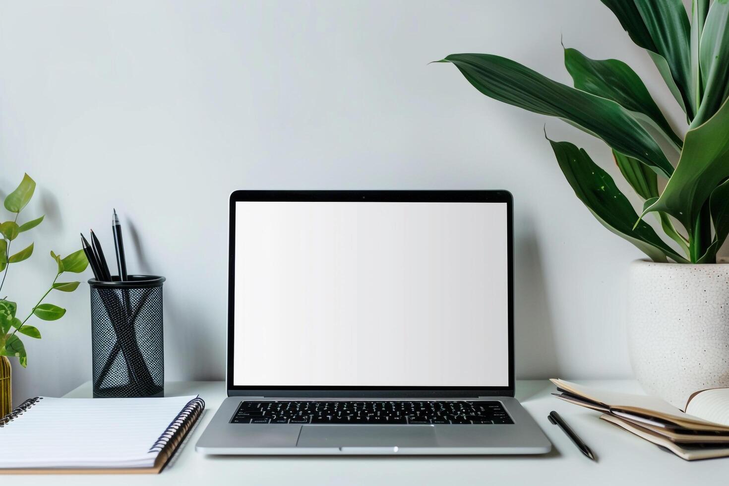 Laptop Mockup Background with pens and notepad on white desk for productivity photo