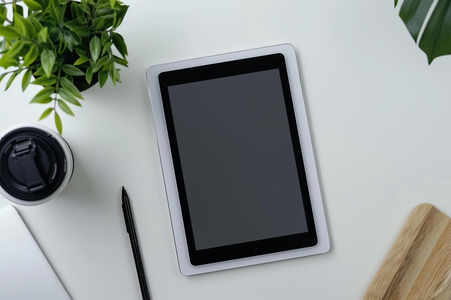 Tablet Displayed on White Desk with Greenery and Office Decor photo