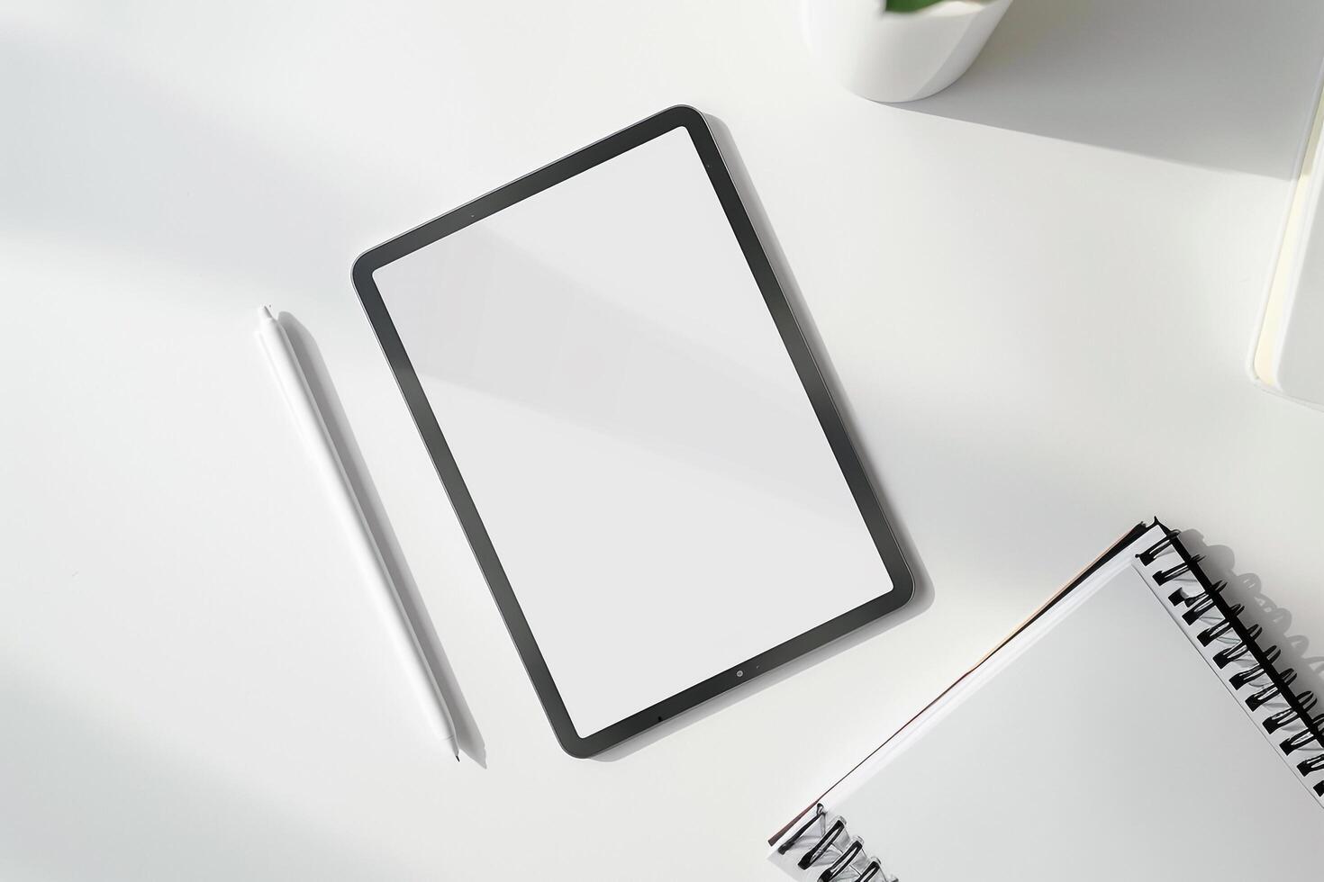 Tablet on Desk with Pen and Notepad and Keyboard photo
