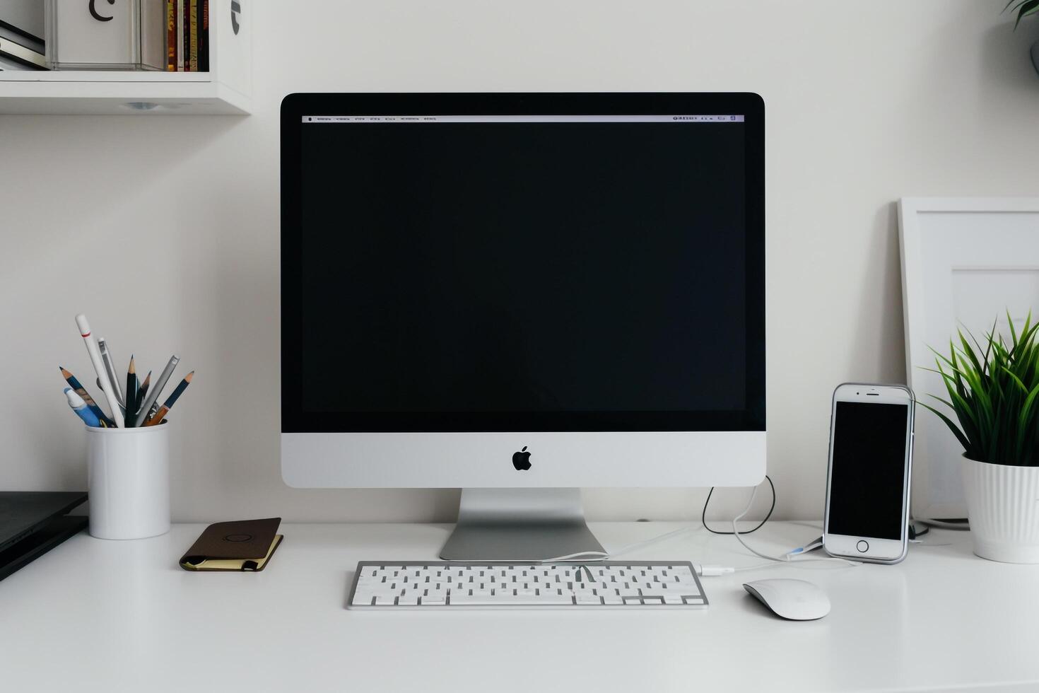 White Desk Computer Mockup Surrounded by Writing Materials photo
