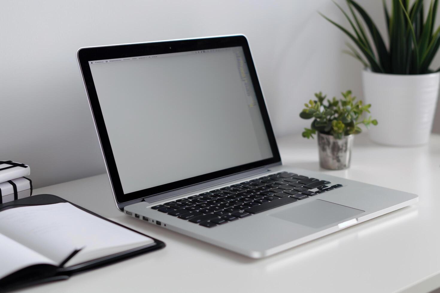 Laptop Mockup with Blank Notebook Open on White Desk photo