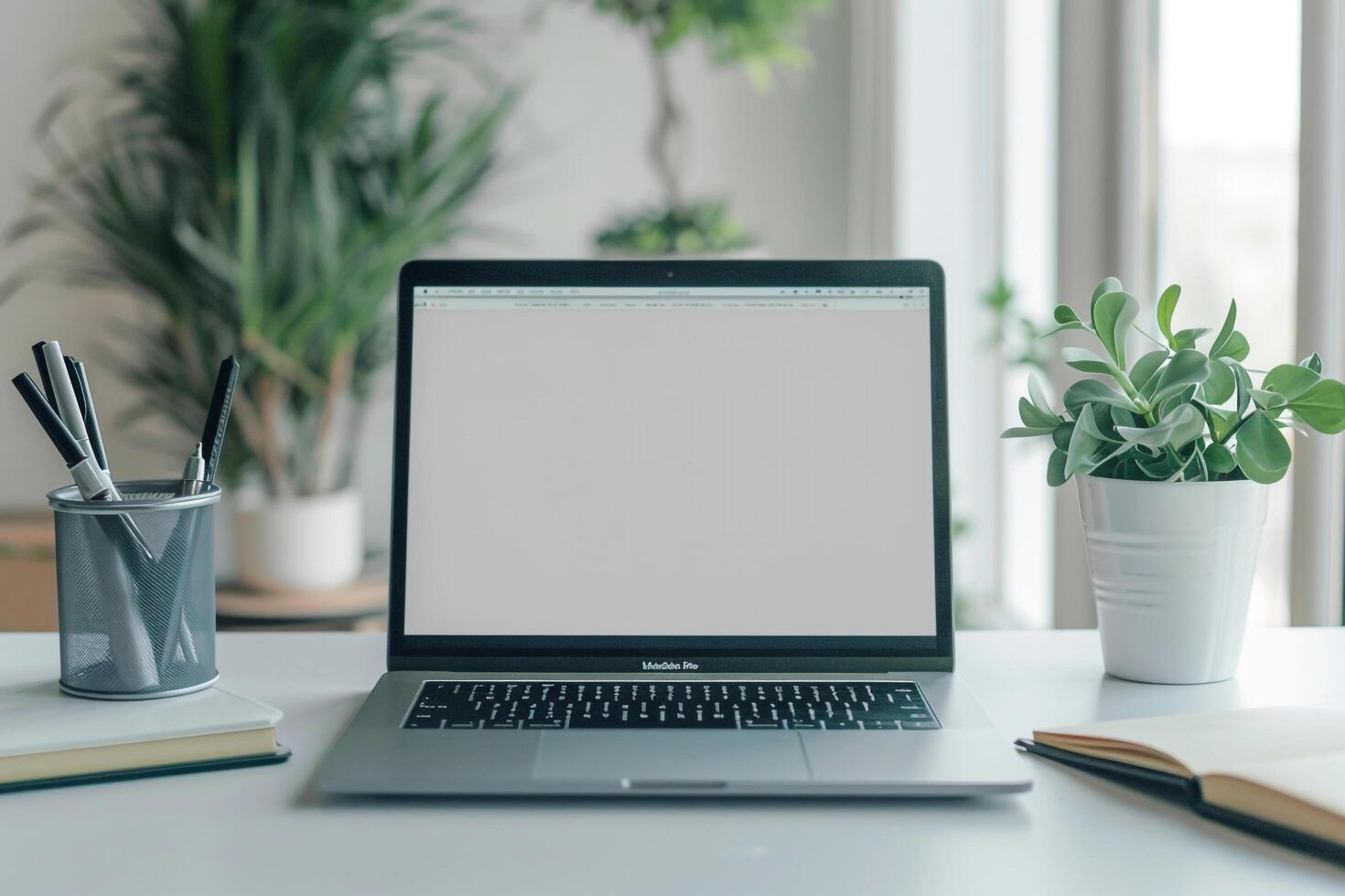 Laptop Mockup with Blank Notebook Open on White Desk photo