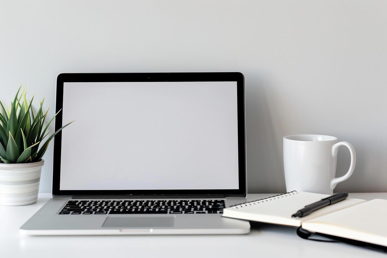 Laptop Mockup with Blank Notebook Open on White Desk photo