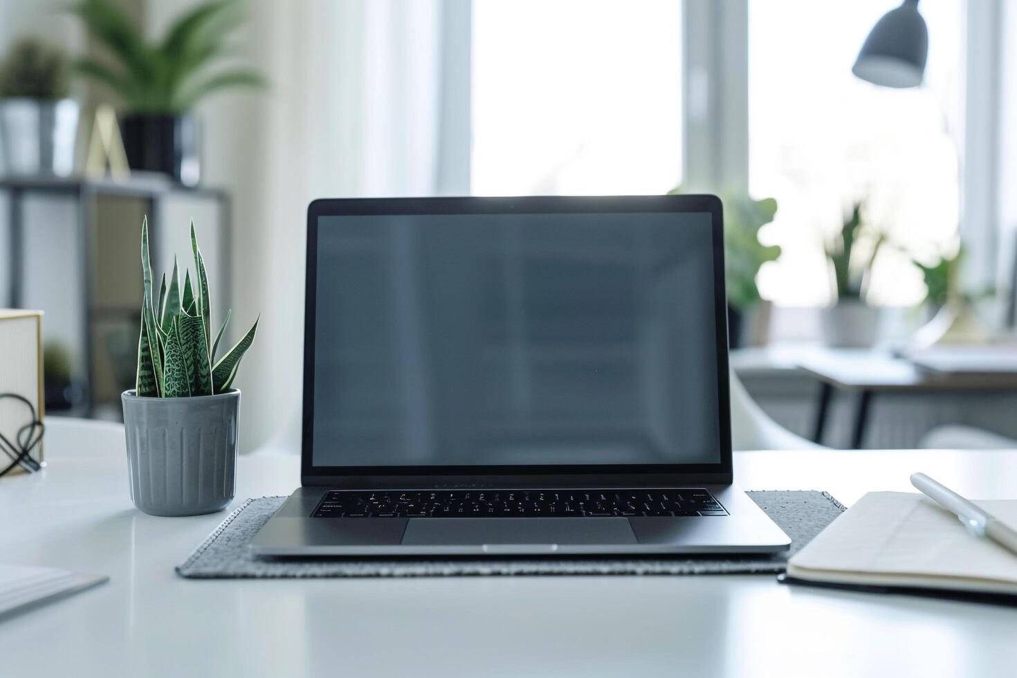 Laptop Mockup with Blank Notebook Open on White Desk photo
