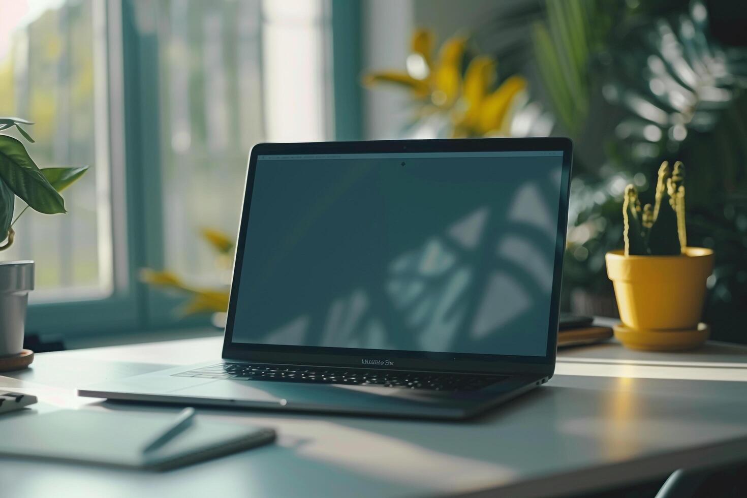 Work and Writing Setup with Laptop Mockup and Open Notebook on White Desk Background photo