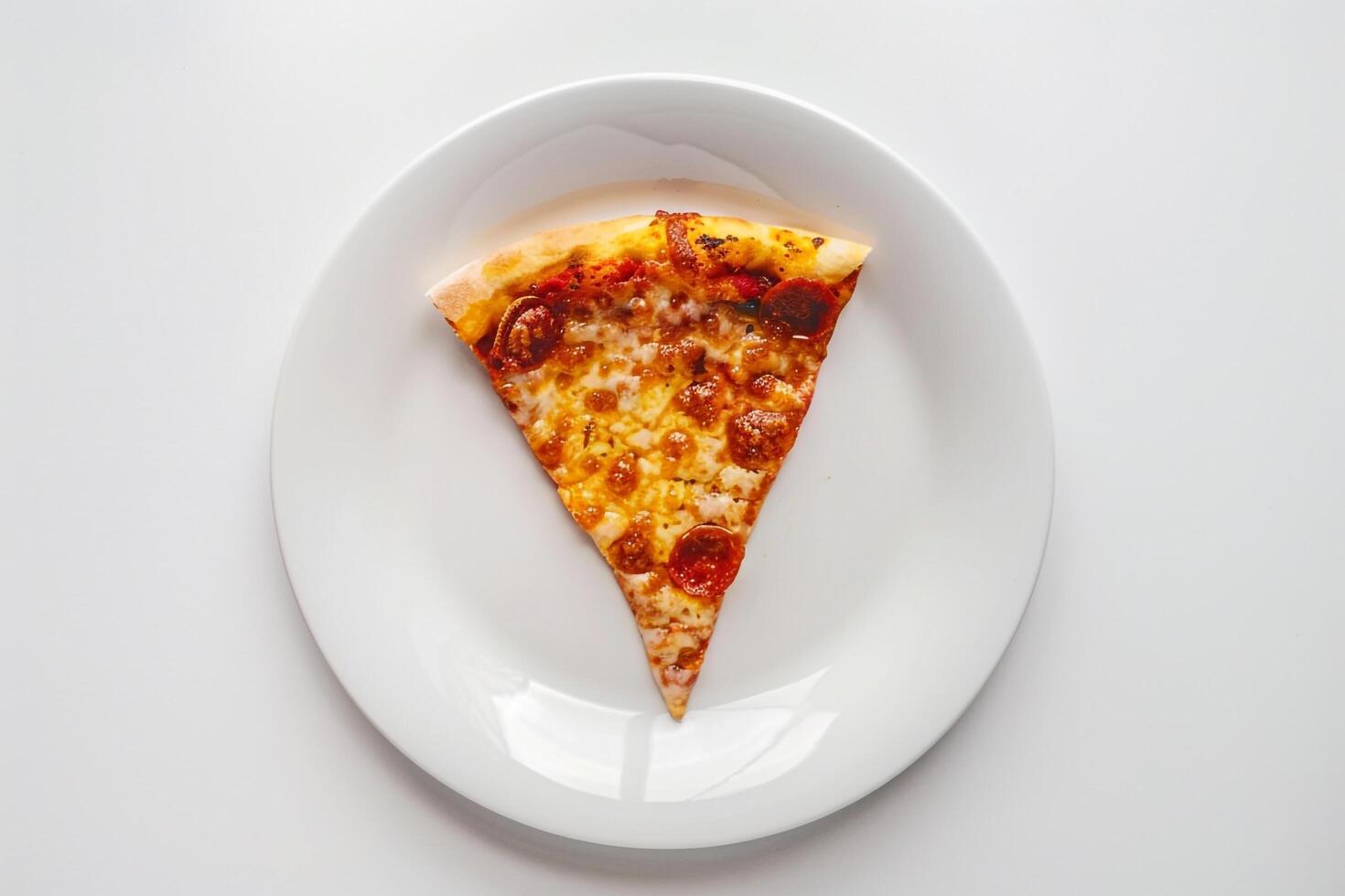 Desktop arrangement with a slice of pizza on a white plate photo