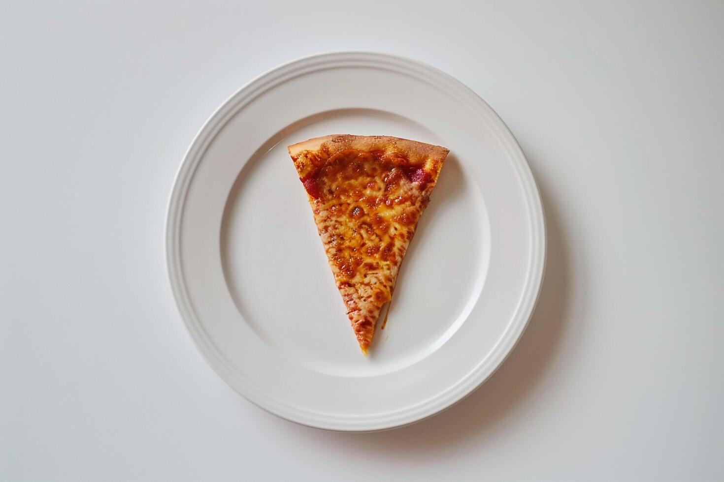 Desktop   with a slice of pizza on a white plate photo