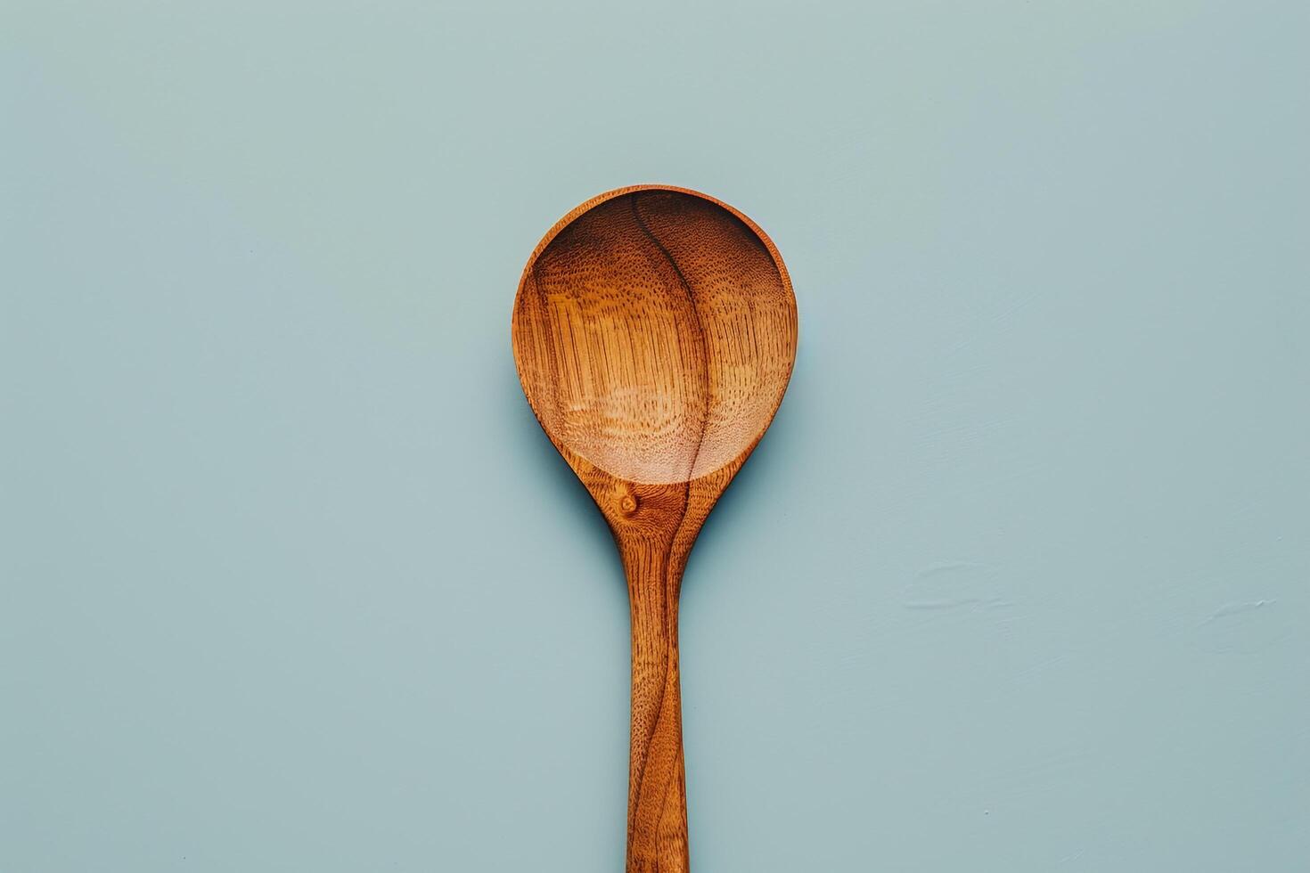 Single Wooden Spoon on a   Background for Cooking and Food Preparation photo
