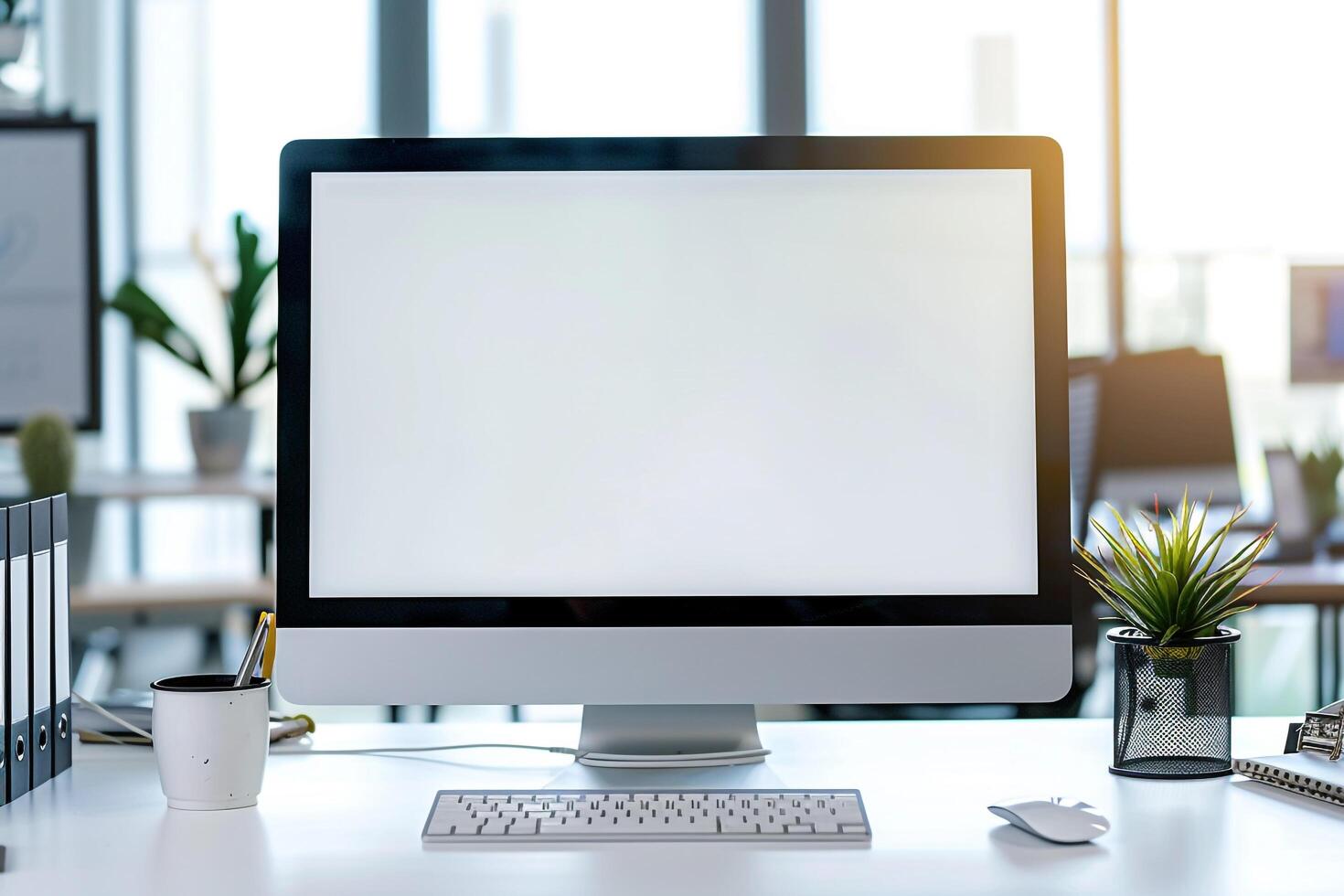 Computer Mockup on White Desk with Various Marketing Materials photo