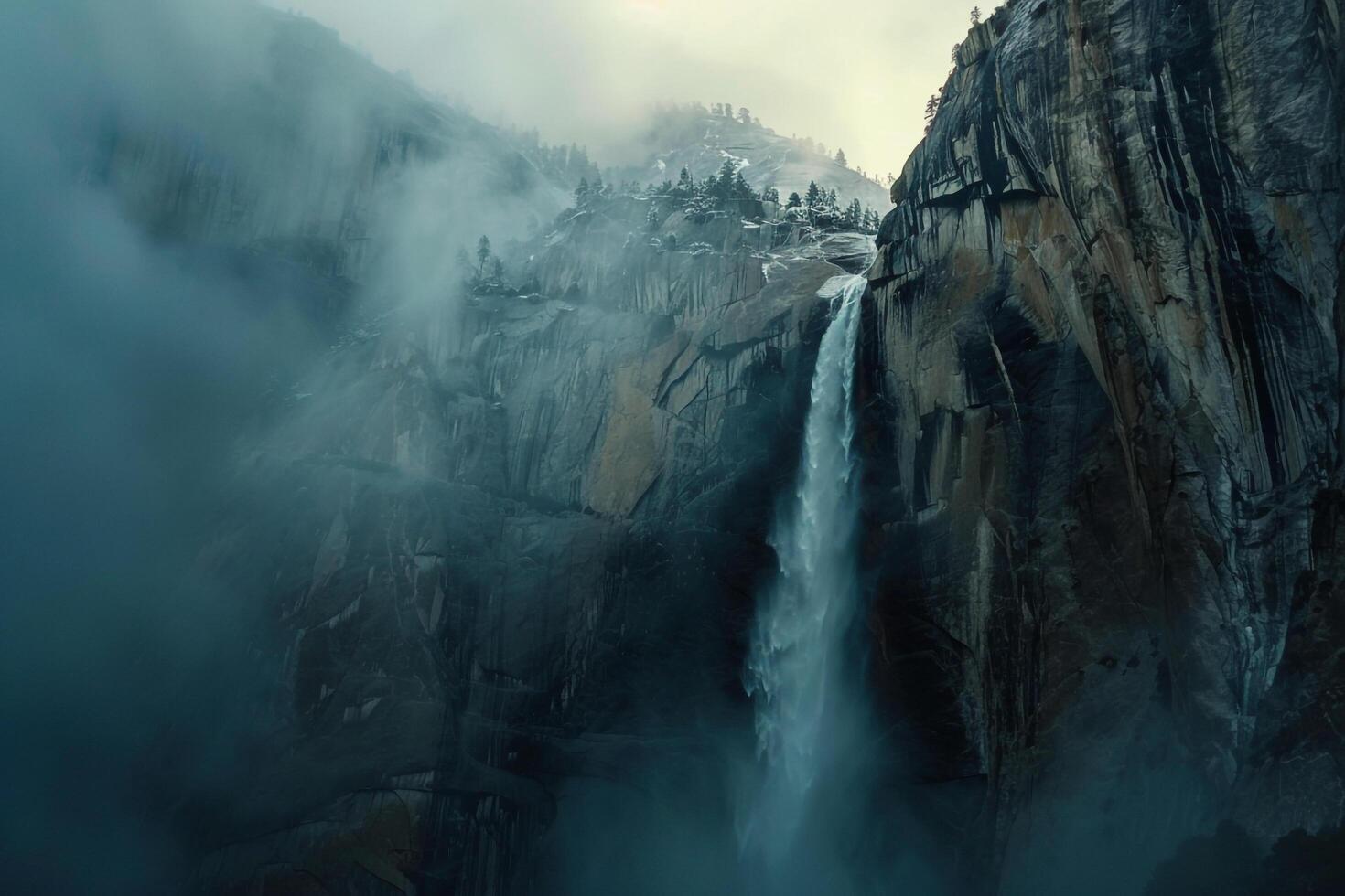 Towering Waterfall Cascading Down Rugged Cliffs in Yosemite National Park with a Scenic  Background photo