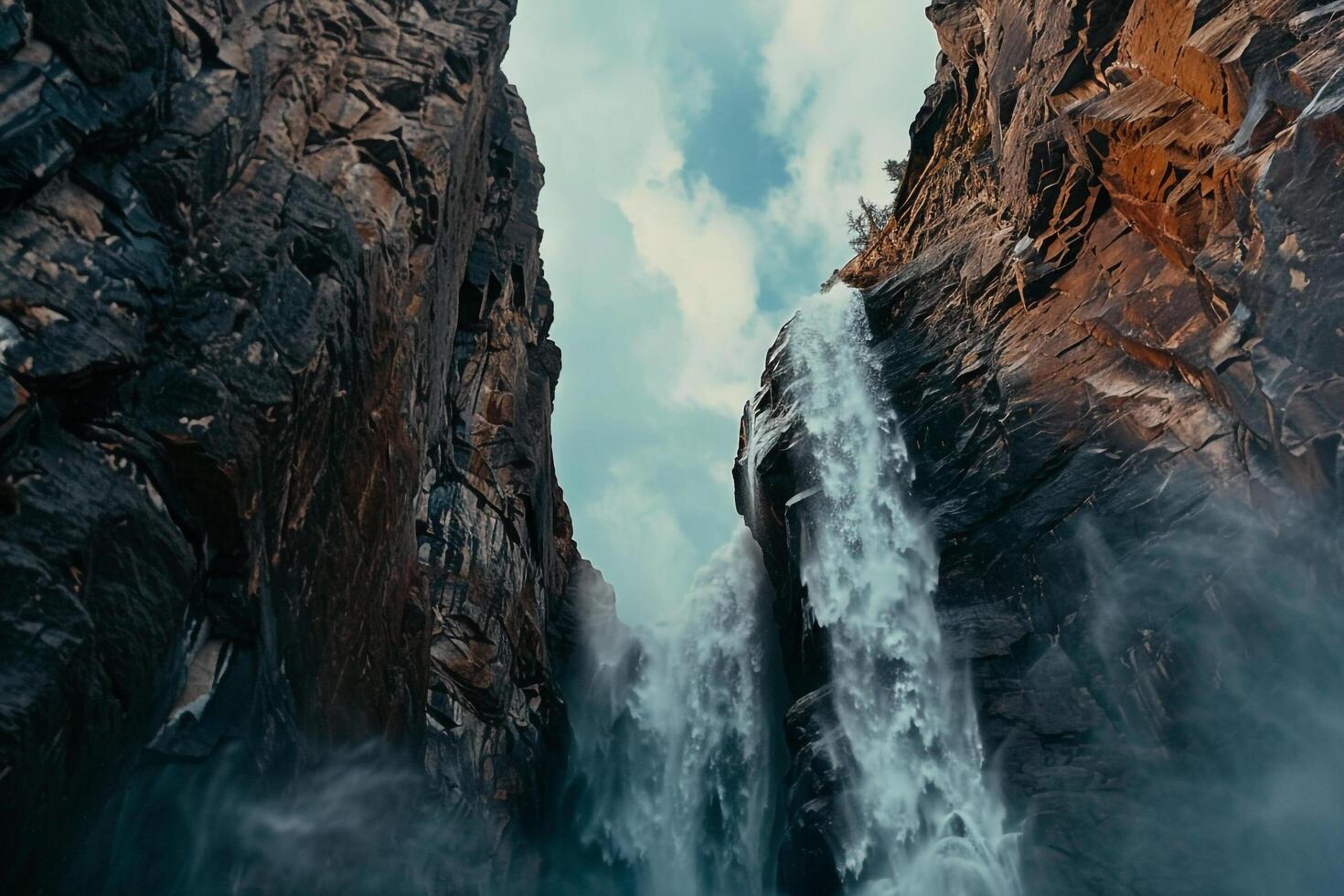 Towering Waterfall Cascading Down Rugged Cliffs in Yosemite National Park with Dramatic Natural  ry photo