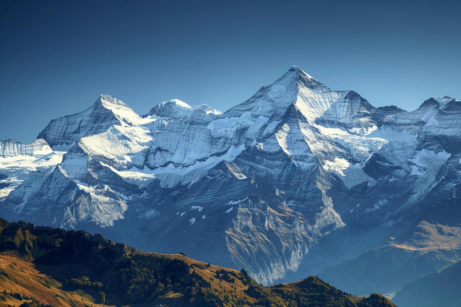 Snow Capped Peaks of the Swiss Alps Under a   Blue Sky photo