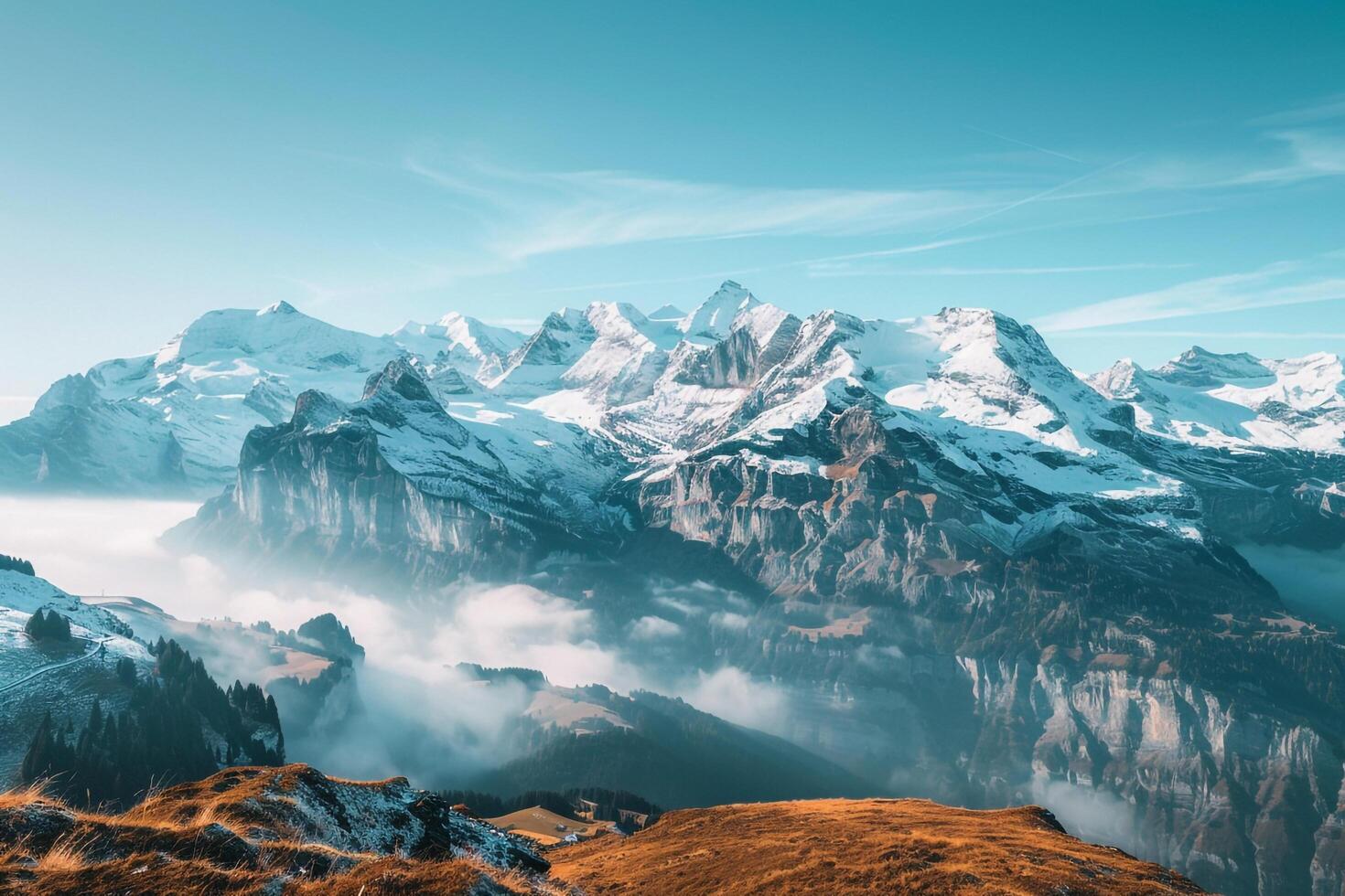 Snow Capped Peaks of the Swiss Alps Be h a Stunning Blue Sky photo