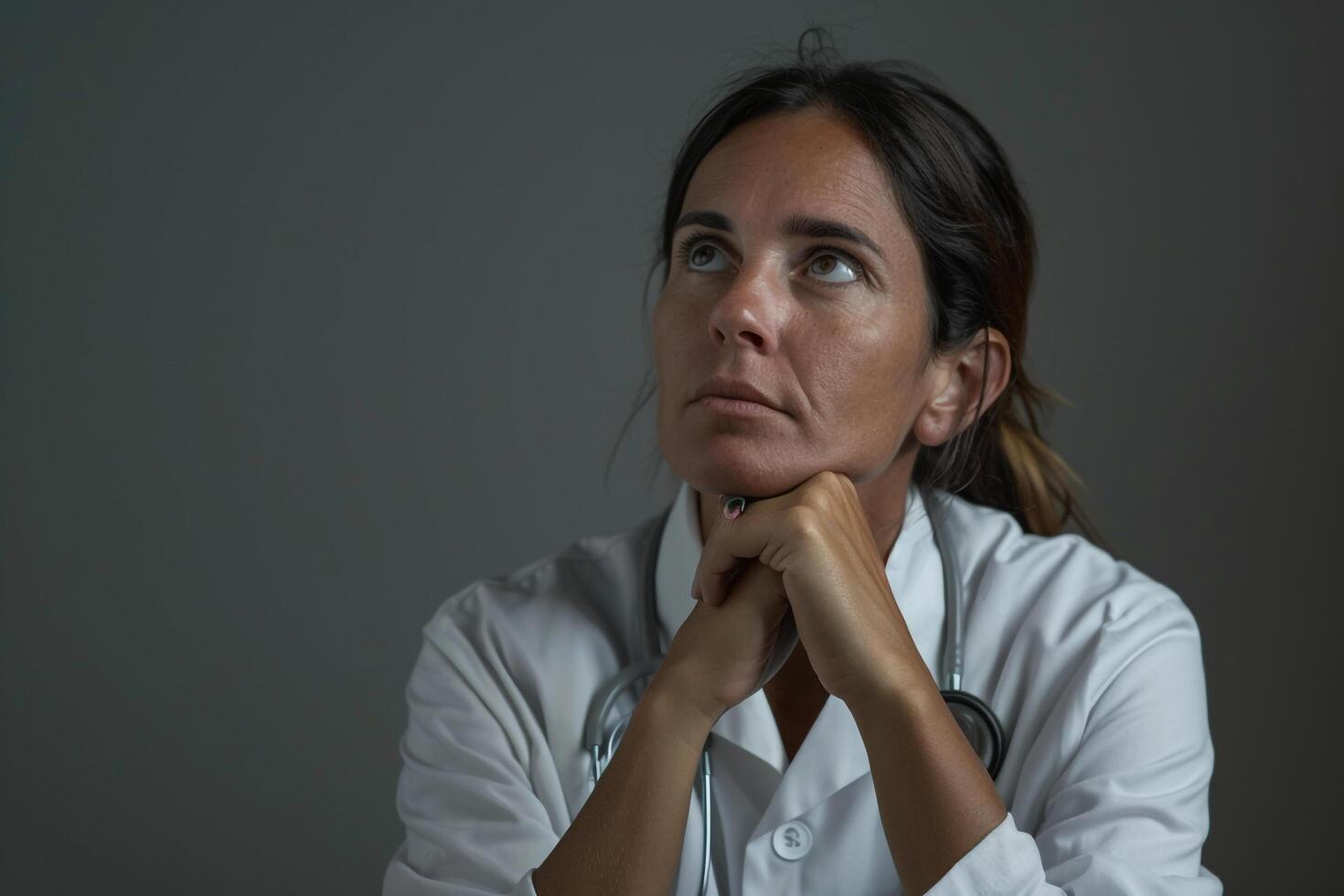 Female Doctor Deep in Contemplation in Healthcare photo