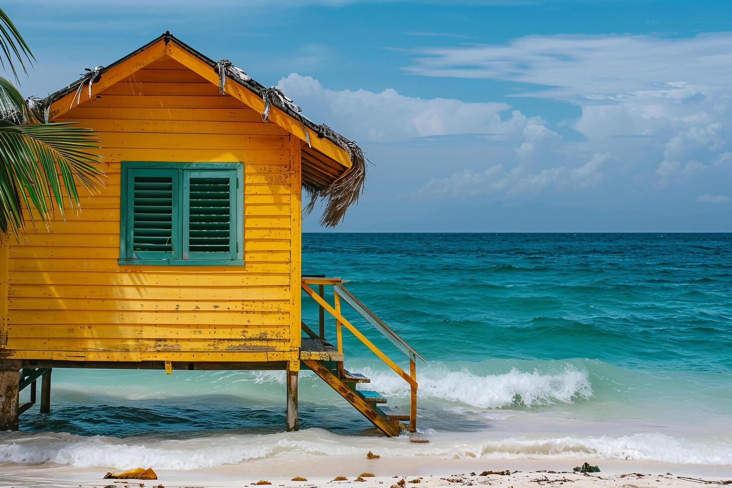 Beach hut on tropical shore with turquoise waves photo