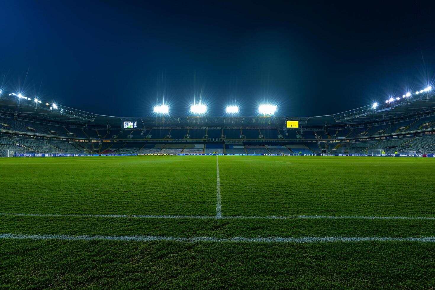 Wide   of Soccer Field with Stadium Lights On and Empty Stands Emphasizing an Expansive and Illuminated Sports Venue photo